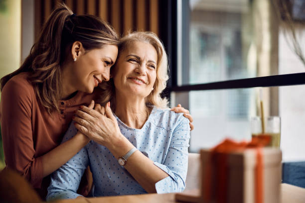 Thank you for all the love you have given me, Mom! Happy senior woman enjoying in daughter's affection on Mother's day. adult offspring photos stock pictures, royalty-free photos & images