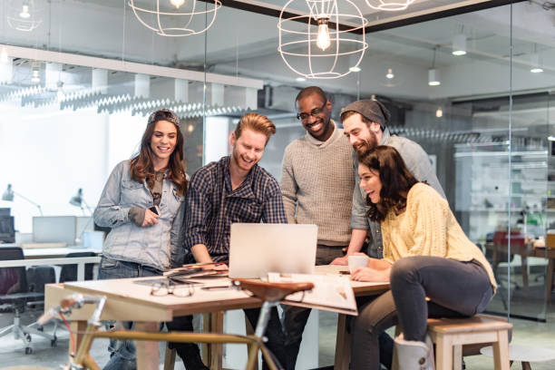 istock Happy freelance workers working on laptop on a meeting in the office. 1385633438