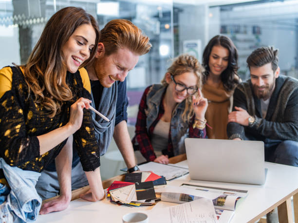 istock Young creative people working on different things at casual office. 1385633754