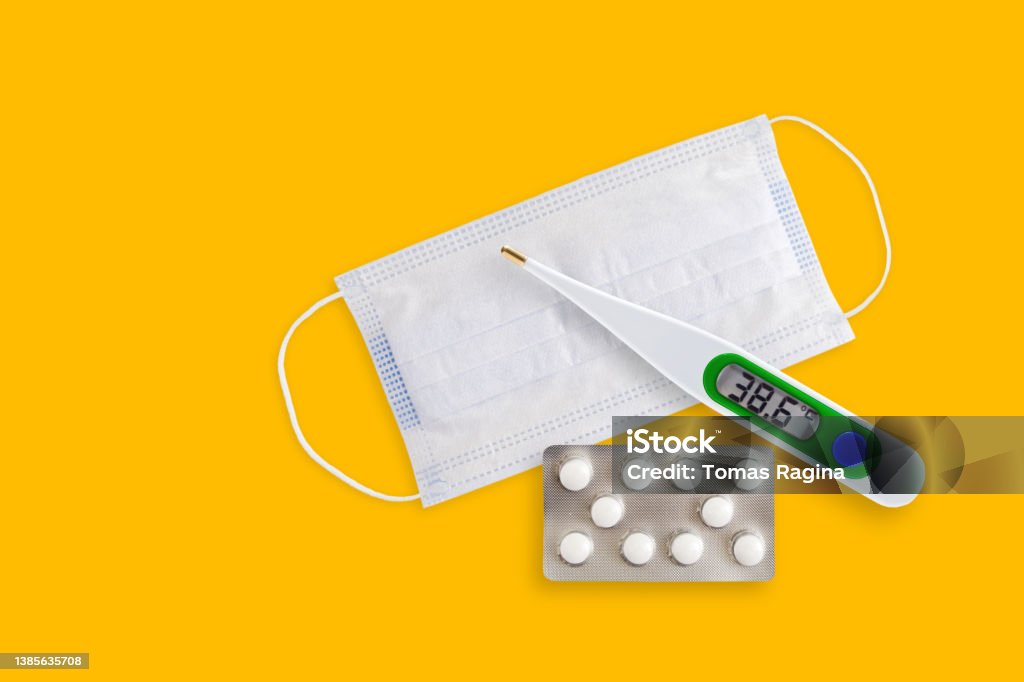 Covid 211218 1Face masks, thermometer and pills isolated on a yellow background. Covid 19 alpha, beta, gamma, delta, lambda, mu, omicron variants outbreak around the world. Face masks, thermometer and pills isolated on a yellow background. Covid 19 alpha, beta, gamma, delta, lambda, mu, omicron variants outbreak around the world. COVID-19 Stock Photo