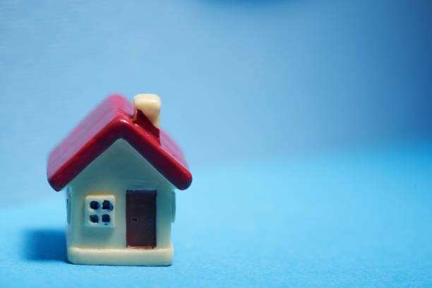 small model house against blue background