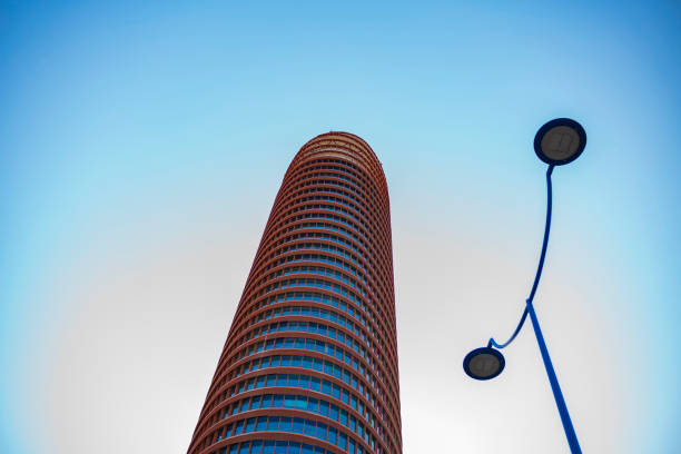 Seville, Spain, June 28, 2018: The Sevilla Tower, known until 2015 as the Cajasol Tower or Pelli Tower, is an office skyscraper photographed with a clear sky in the background.