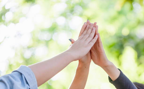 istock Group girls hands together giving high five feels excited close up focus on stacked palms. celebration and friendship concept 1385646659