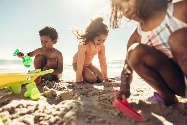 istock Young friends playing with their toys at the beach 1385647827