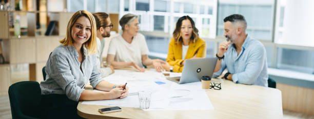 istock Successful young designer sitting in a meeting with her team 1385647992