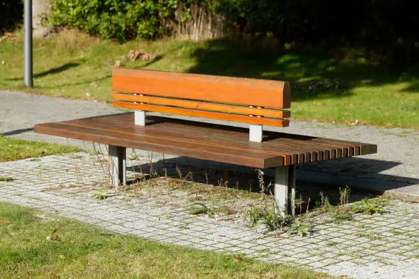 Modern wooden bench in a park, Germany, Europe