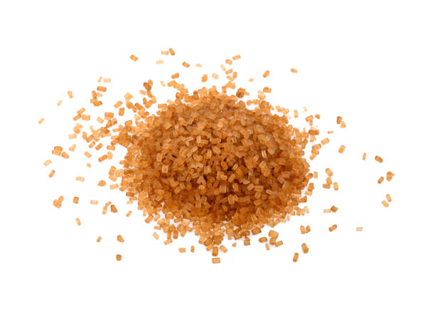 Crystals cane sugar, brown caramel cane sugar isolated on white background