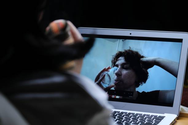 istock Woman is videocalling her friend while staying in bed with flu 1385664491