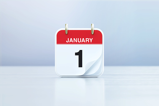 January 1 calendar sitting on white reflective background. Horizontal composition with copy space. Front view. Calendar and reminder concept.