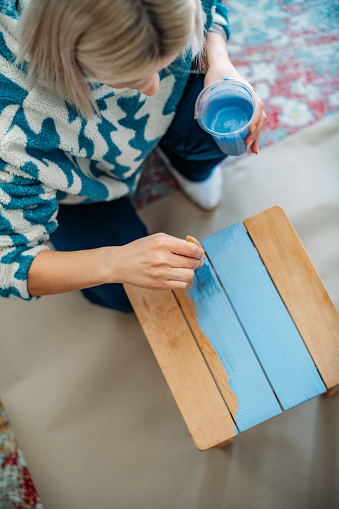 Flat Lay Young Woman Painting a Chair at Home