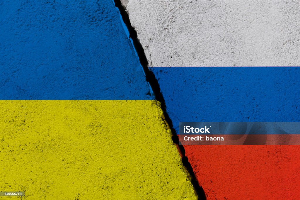 Russian and Ukrainian flags on broken cracked wall Russian and Ukrainian flags on broken cracked wall. Russian Flag Stock Photo