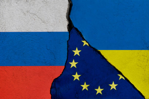istock Ukrainian, European Union and Russian flags on broken cracked wall 1385667147