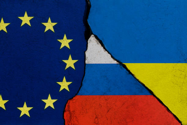 istock Ukrainian, European Union and Russian flags on broken cracked wall 1385667163
