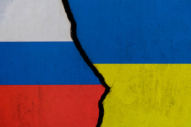 istock Russian and Ukrainian flags on broken cracked wall 1385667190