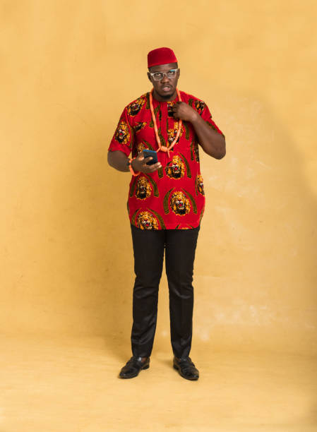 istock Igbo Traditionally Dressed Business Man Standing with Phone in Hand Looking 1385668122