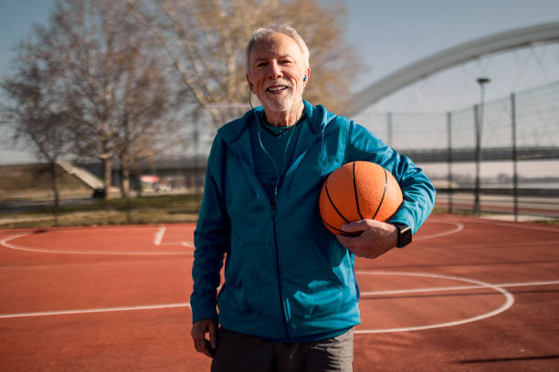 istock Senior taking a break on a basketball court posing looking at camera 1385668163