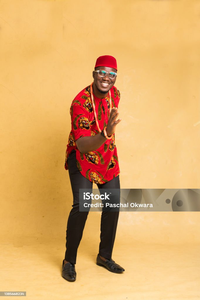 Igbo Traditionally Dressed Business Man Standing Dancing with Hand forward Nigeria Stock Photo