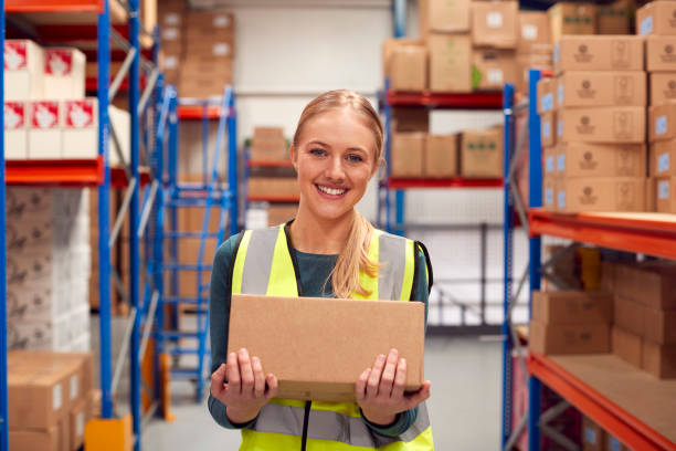 istock Portrait Of Female Worker Holding Box Inside Warehouse 1385668540