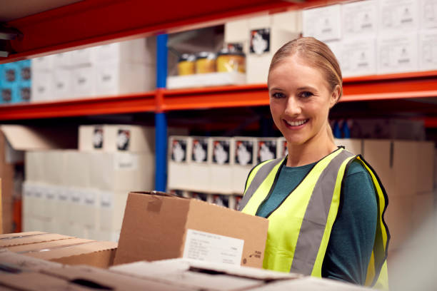 istock Portrait Of Female Worker Picking Box From Shelf Inside Warehouse 1385668578