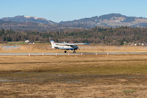 Wangen-Lachen, Switzerland, February 27, 2022 Cessna 152 propeller plane is taxiing on a small airfield