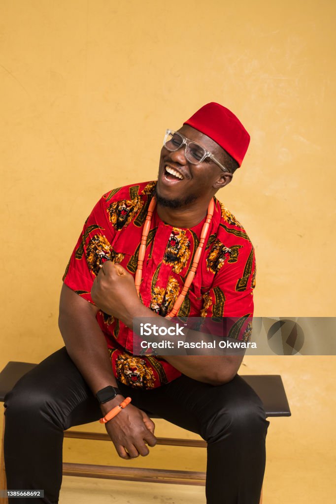 Igbo Traditionally Dressed Business Man Sitting Down and Laughing Africa Stock Photo