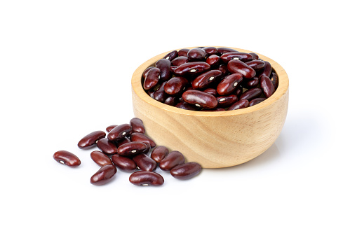Red kidney bean in wooden bowl isolated on white background.