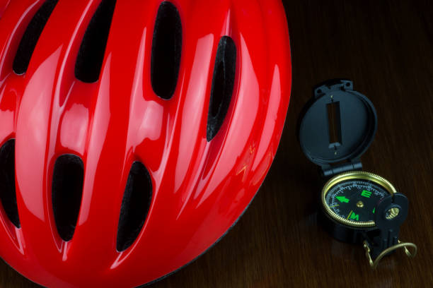 istock Red Cycle Helmet and Compass on a Polished Wooden Surface 1385677568