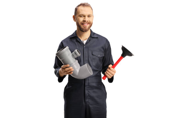 Plumber holding a pipe and a toilet plunger isolated on white background