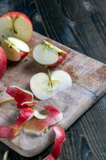 istock cutting old board with pieces of red ripe apple 1385683321