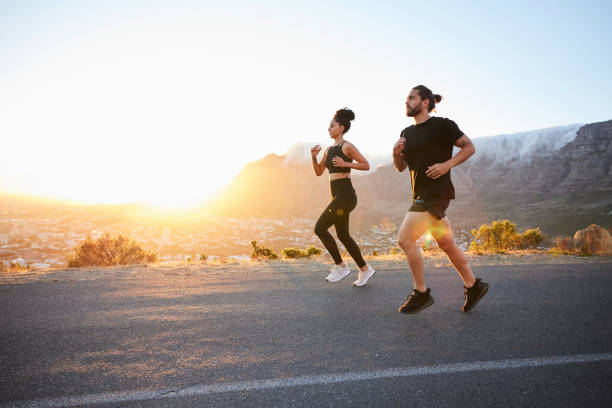 istock Fit young couple running along a scenic trail at sunset 1385688681