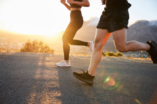 istock Two fit people running along a scenic trail together at sunset 1385688775