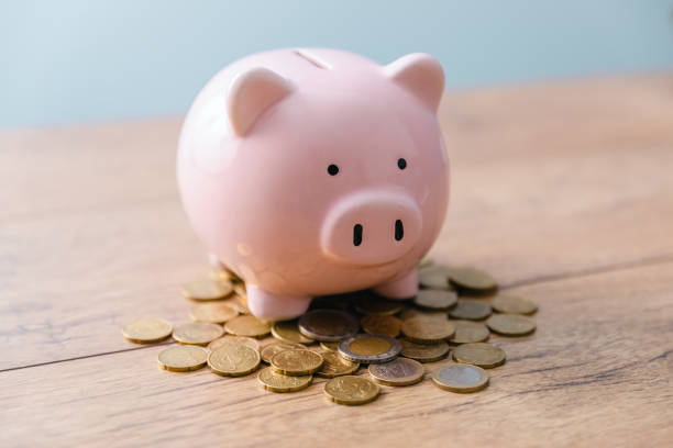 istock piggy bank with coins 1385690019