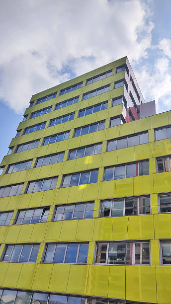 istock modern and contemporary green building against a blue cloudy sky 1385690425