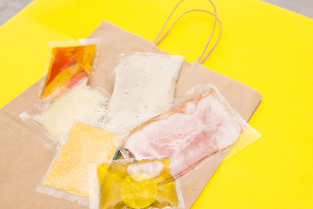 istock Salad dinner set: chicken, lettuce, tomatoes, peking cabbage, cheese, bacon, bread, olive oil sauces and spices. A set for delivering food for dinner on a yellow background. I cook at home 1385690799