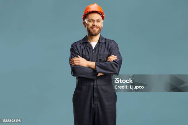 Technician In A Uniform With A Helmet And Goggles Stock Photo - Download Image Now - Coveralls, Cut Out, Portrait