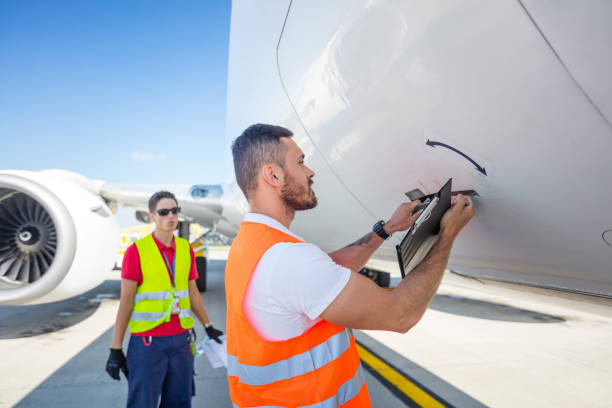istock Airport ground service, men next to airplane 1385693568
