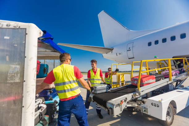 istock Airport service crew loading luggage 1385693824