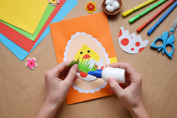 istock Making of handmade Easter decoration. Child made greeting card in egg shape. Childrens DIY concept, gift with your own hands. Hobby, paper crafts at home or  in kindergarten. 1385694017