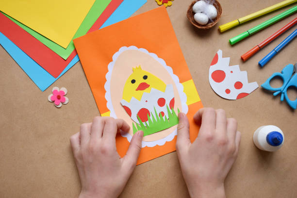 istock Making of handmade Easter decoration. Child made greeting card in egg shape. Childrens DIY concept, gift with your own hands. Hobby, paper crafts at home or  in kindergarten. 1385694019