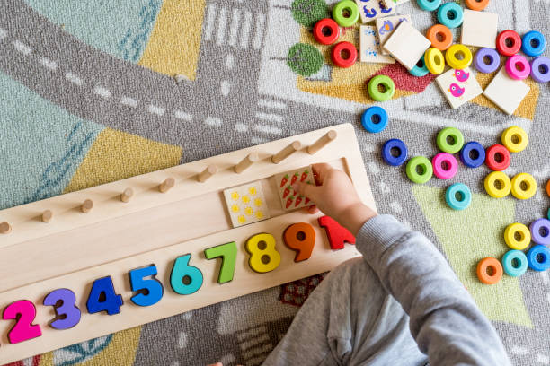 Baby toddler early development. Wooden stack and count rainbow colors learning game. Child learn colors and numbers Baby toddler early development. Wooden stack and count rainbow colored learning game. Child learn colors and numbers child care stock pictures, royalty-free photos & images
