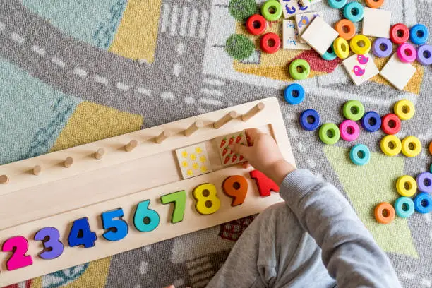 Baby toddler early development. Wooden stack and count rainbow colored learning game. Child learn colors and numbers
