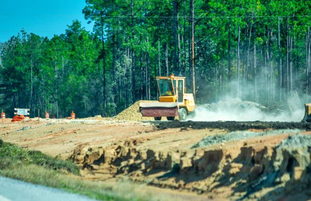 istock Tractor for road works along a major road. 1385694045