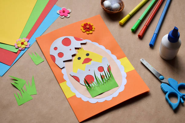 istock Making of handmade Easter decoration. Child made greeting card in egg shape. Childrens DIY concept, gift with your own hands. Hobby, paper crafts at home or  in kindergarten. 1385694062