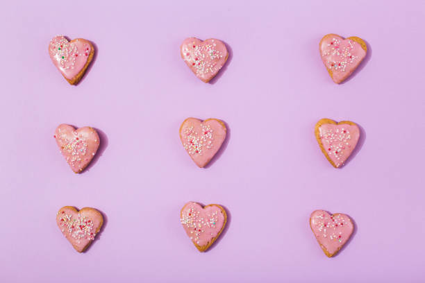 istock Tasty heart shaped cookies on pink background 1385695322