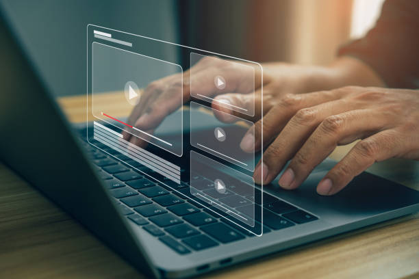 istock Businessman hands using laptop for streaming online, watching video on internet. 1385695930