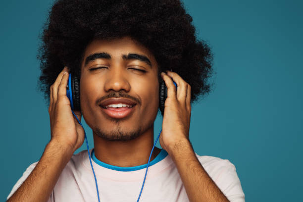 istock African american man with african hairstyle using phone 1385697594
