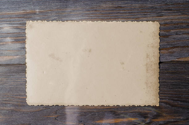 An old photo on a wooden brown background. Copy space.