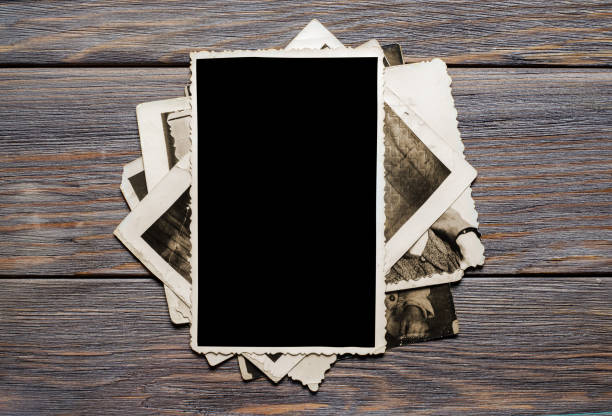 istock Old photos on a wooden brown background. Copy space 1385698279