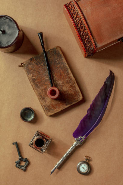 istock Vintage pipe, notebook, a quill pen, and a retro watch. Private investigation 1385698714