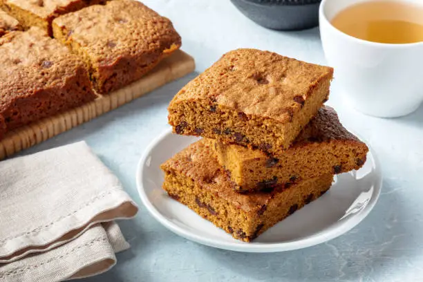 Blondie brownie dessert bars with chocolate chips, a stack with tea